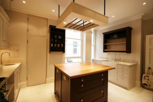 Two colour Hand-painted Kitchen with Oak interiors and stone and Oak worksurfaces.