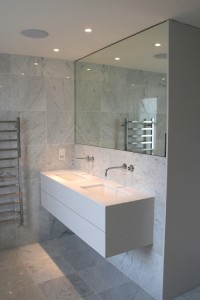 Spray-painted Vanity Unit with mitred stone top and Walnut drawers and interior.  Mirrored door cabinet recessed into wall with a white sprayed interior.