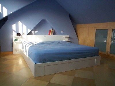 Bed with drawers spray-finished in a white lacquer.
