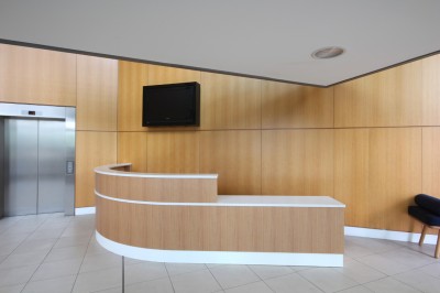 Reception Desk made from Quarter sawn European Oak veneers and composite stone top for the centre court reception at the New England Tennis and Croquette Club.  Designed by Opus Magnum.
